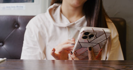 Woman use of mobile phone in coffee shopの写真素材