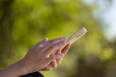 Woman use smartphone at parkの写真素材