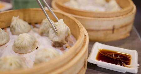 Chinese style steamed soup bun in restaurantの写真素材