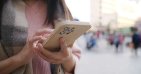 Woman search on cellphone at outdoorの写真素材