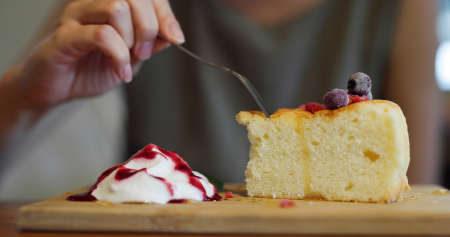 Woman enjoy her cake at cafeの写真素材