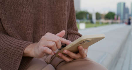 Woman use of mobile phone at outdoorの写真素材