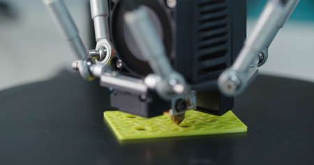 3D Printing Machine printing a piece of plasticの写真素材