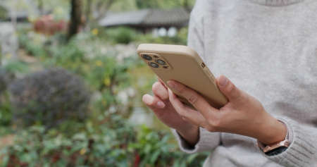 Woman use of mobile phone at outdoorの写真素材