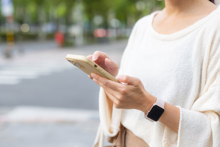 Woman use smart phone in cityの写真素材