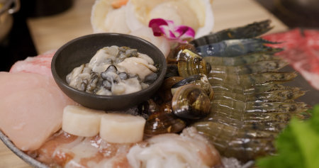Bowl of seafood for hotpot in restaurantの写真素材
