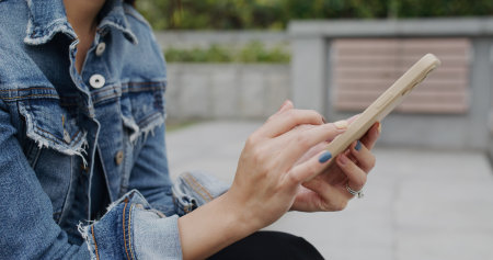 Woman use of mobile phone at outdoorの写真素材