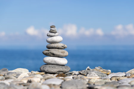 Rock balancing on ocean beachの写真素材