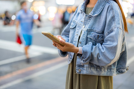 Woman use mobile phone in cityの写真素材