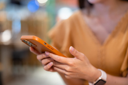 Woman use mobile phone at restaurantの写真素材