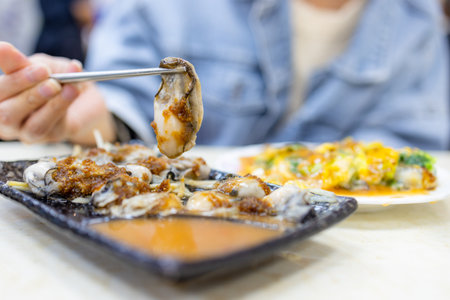 Fresh oyster with sauce in restaurantの写真素材