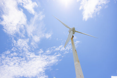 Wind turbine over the blue sky