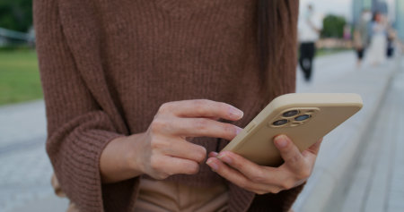 Woman use cellphone in cityの写真素材