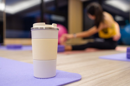 Woman drink her water bottle in yoga room