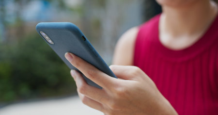 Woman use of mobile phone in cityの写真素材