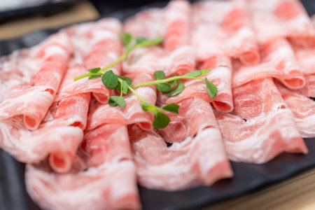 Slice of fresh raw pork at hot pot restaurantの写真素材