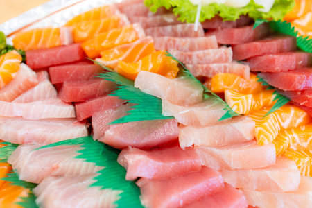 Variety of sashimi in plastic boxの写真素材