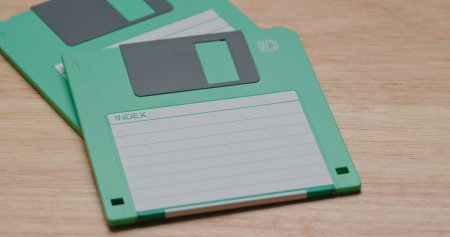 Two Green floppy disc on table
