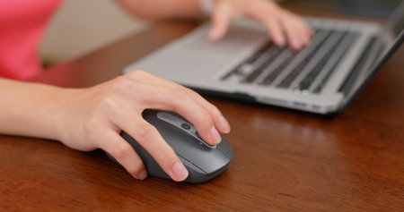 Woman work on computer with mouse at office