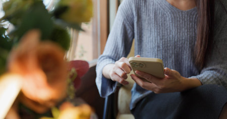 Woman use smart phone at coffee shopの写真素材