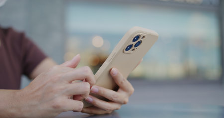 Woman use of smart phone at outdoor parkの写真素材