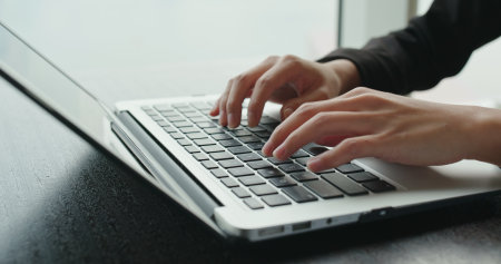 Woman working on laptop computerの写真素材