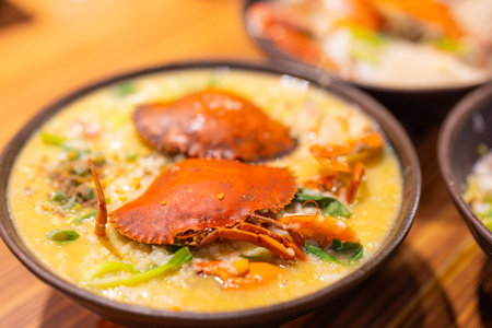 Seafood congee bowl with crab in restaurantの写真素材