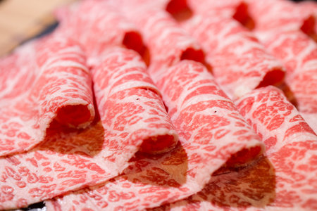 Fresh slice of the beef in hot pot restaurantの写真素材