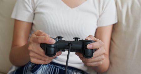 Woman play game console at home