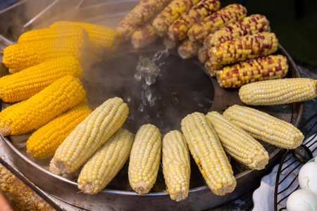 Steamed of different corn sell in street marketの写真素材