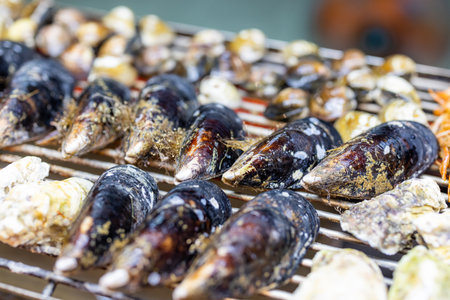 Mixed seafood barbecue on grill metal netの写真素材