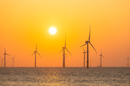 Wind turbine field over the sea in the evening