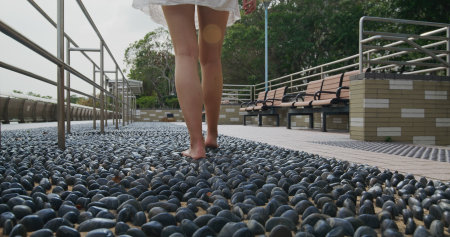 Woman walk on stone pathの写真素材