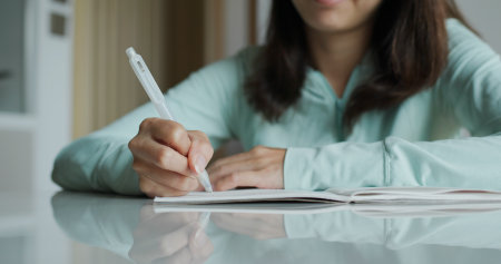 Woman write on notebook at homeの写真素材