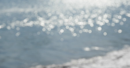 Blur of sea wave with sunlight sparkleの写真素材