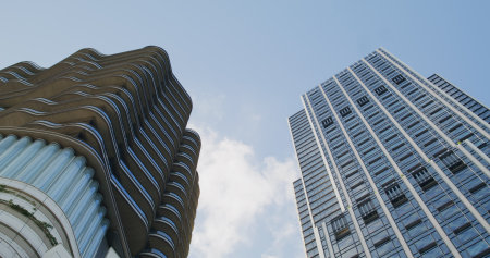 Tsim Sha Tsui, Hong Kong 09 September 2021: Low angle of the business building tower with white...
