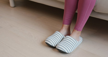 Woman wearing slipper at homeの写真素材