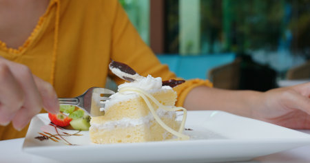 Woman eat cake at coffee shop