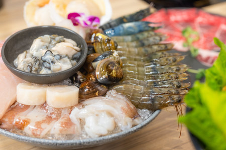 Bowl of seafood for hotpot in restaurantの写真素材