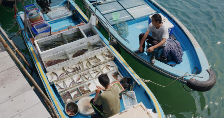 Sai Kung, Hong Kong 30 March 2021: Top down view of fishing boat selling seafoodの写真素材