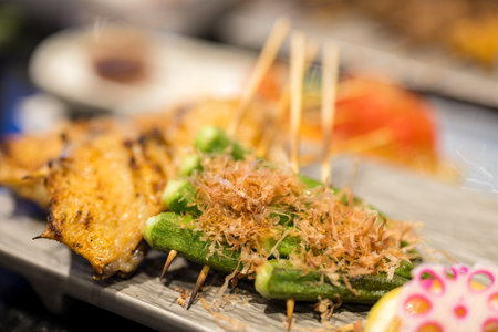 Skewers with chicken wing and okra in restaurantの写真素材