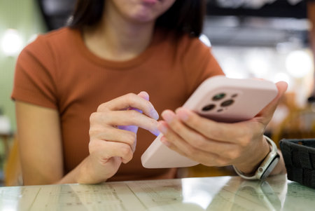 Woman use mobile phone at restaurant