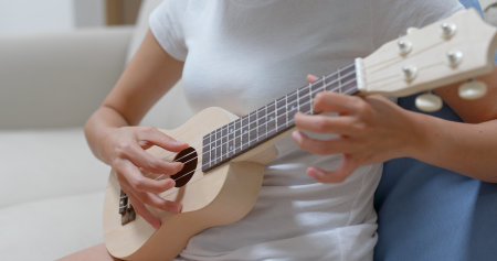 Woman play ukulele with a songの写真素材