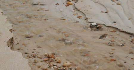 Sea water flow though to the beachの写真素材