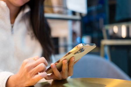 Woman use of mobile phone in cafeの写真素材