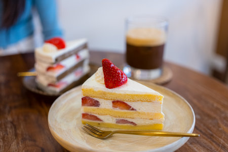 Slice of strawberry cake with coffee