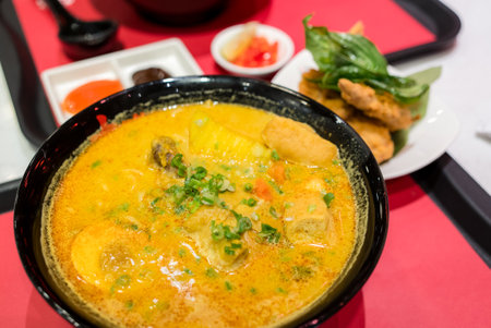 Curry noodles bowl in the restaurantの写真素材