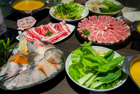 Slice of beef and vegetable for hotpot at restaurantの写真素材