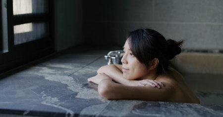 Woman enjoy her hot spring at winter timeの写真素材