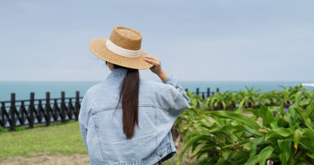 Woman look at the sea in north coast of taiwanの写真素材